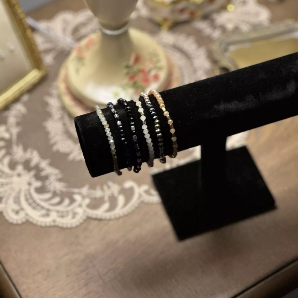 black, white, and sliver beaded bracelets.